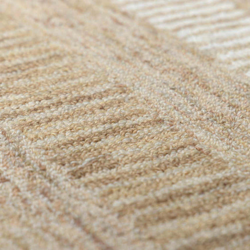Close-up of the tan Yoyko Area Rug. Hand-tufted wool rug with a subtle geometric pattern. Soft texture. Texture