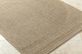 Close-up of the tan Yuley Brown Area Rug showing its woven texture and border detail. Corner