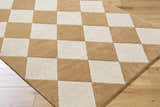 Close-up of the Aradia Tan Area Rug. Hand-tufted wool rug with a contemporary tan and ivory checkerboard pattern. Corner