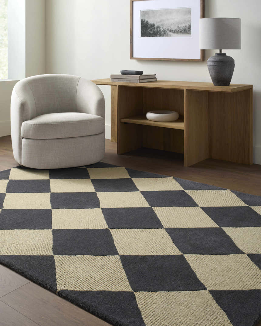 Living room scene with Aradia Charcoal Area Rug, beige chair, and wood console table with lamp. Roomscene-Rectangle