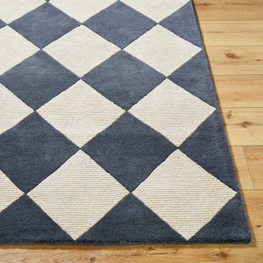 Close up of the Aradia Charcoal Area Rug. Hand-tufted wool rug with a contemporary diamond pattern in charcoal and cream. Front