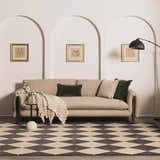 Living room scene with a beige sofa on the Aradia Charcoal Area Rug. Diamond pattern rug adds a modern touch. Roomscene-Rectangle