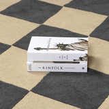 Close up of the Aradia Charcoal Area Rug showing its geometric checkerboard pattern and wool texture. Styleshot