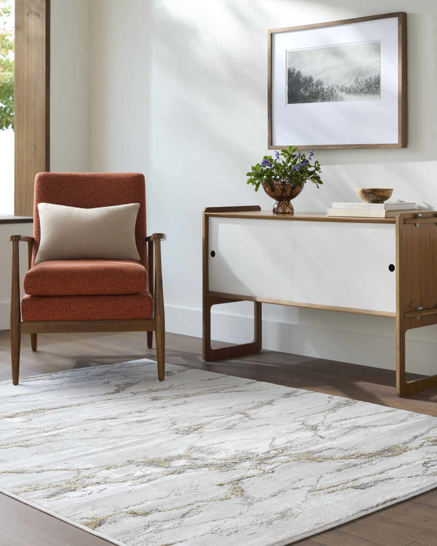 Living room scene with a beige Zelah Area Rug, orange chair, and modern white cabinet. Roomscene-Rectangle