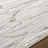 Close up of the Zelah Area Rug showing its ivory, beige, and charcoal contemporary pattern and soft texture. Texture