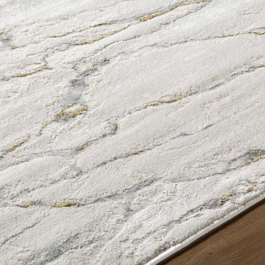 Close up of the Zelah Area Rug showing its ivory, beige, and charcoal contemporary pattern and soft texture. Texture