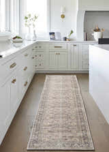 Bright kitchen with white cabinets and wood floors featuring a Zahar Washable Area Rug runner. Roomscene-Runner