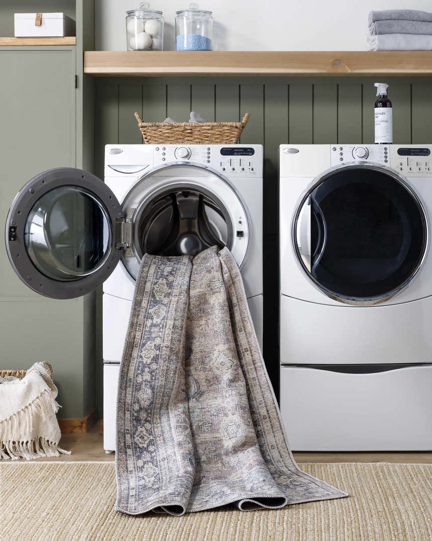 Laundry room scene with Zahar Washable Area Rug partially in washing machine. Farmhouse style with silver gray tones. Washing-Machine