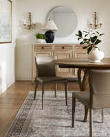Dining room with wood table and Darling Becki Owens x LIVABLISS rug in tan, sage, and dark red. Roomscene-Rectangle