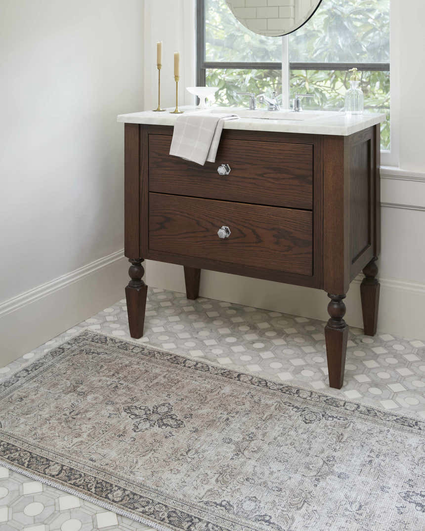 Bathroom scene with a dark wood vanity and the Darling Becki Owens x LIVABLISS runner rug in tan, sage, and dark red. Roomscene-Runner