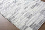 Close-up of the ivory and peach Alaura Area Rug with a contemporary shag design and textured feel. Corner
