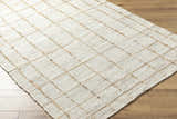 Close-up of the hand woven Zared Checkered Jute Area Rug. The rug is ash and light silver with a farmhouse style. Corner