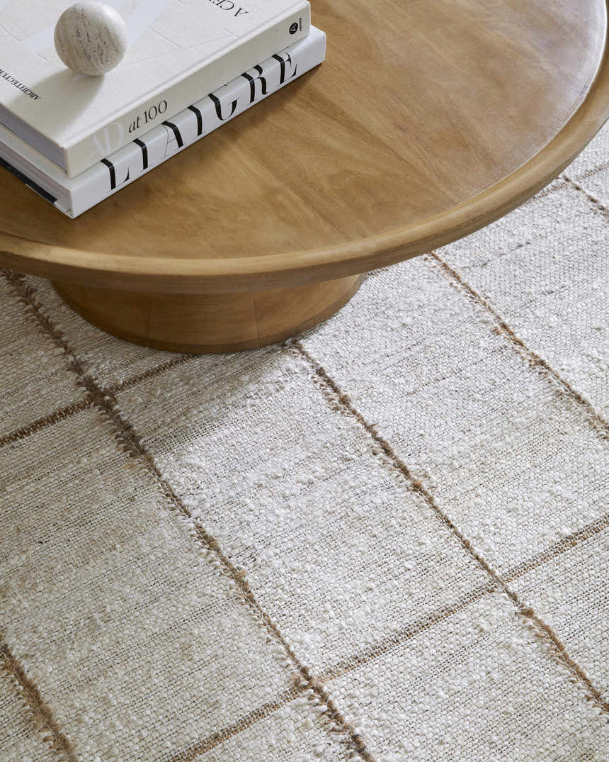Close-up of the Zared Checkered Jute Area Rug showing the texture and ash and light silver color palette. Styleshot