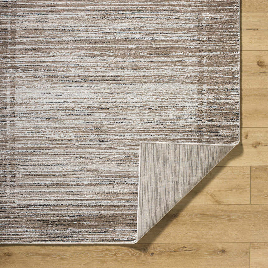 Close-up of Ainhoa Luxe Thick Area Rug showing ivory, tan, and black horizontal stripes and machine-woven construction. Fold