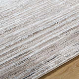 Close-up of Ainhoa Luxe Thick Area Rug, showing ivory, tan, and black linear pattern and plush texture. Texture