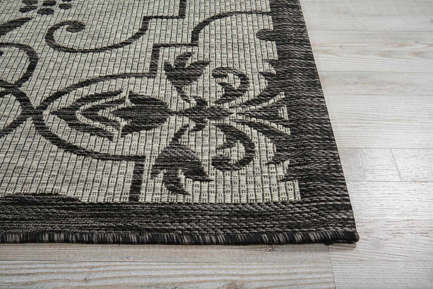 Close up of the ivory and charcoal Nourison Country Side area rug showing the floral pattern and texture.