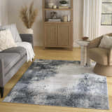 Living room scene with grey sofa and Nourison Dekor Grey Navy rug.