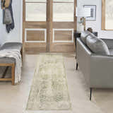 Entryway with gray leather sofa and Nourison Astra Ivory Green Vintage rug runner on light wood floors.