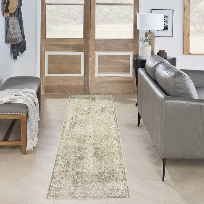 Entryway with gray leather sofa and Nourison Astra Ivory Green Vintage rug runner on light wood floors.