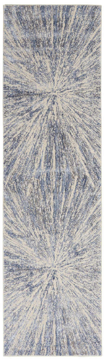 Close-up of Nourison Silky Textures Blue Grey rug. Modern design with radiating blue and gray pattern on a light background.