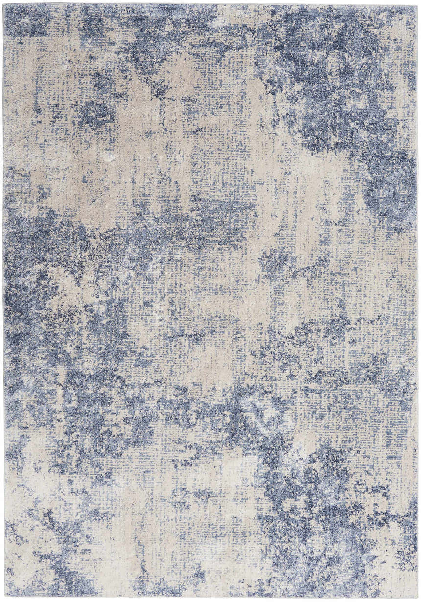 Close-up of Nourison Silky Textures Ivory/Blue rug. Modern design with abstract blue pattern on an ivory background.
