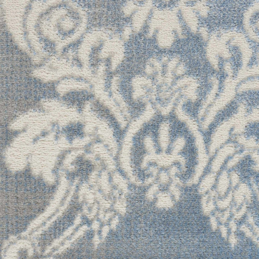 Close-up of the Nourison Elation Ivory Blue Vintage Rug, showcasing its high pile texture and chestnut-toned floral pattern.