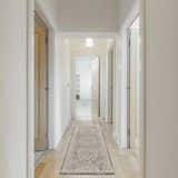 Hallway with a Nourison Lynx Ivory Charcoal Vintage Area Rug runner on light wood floors.