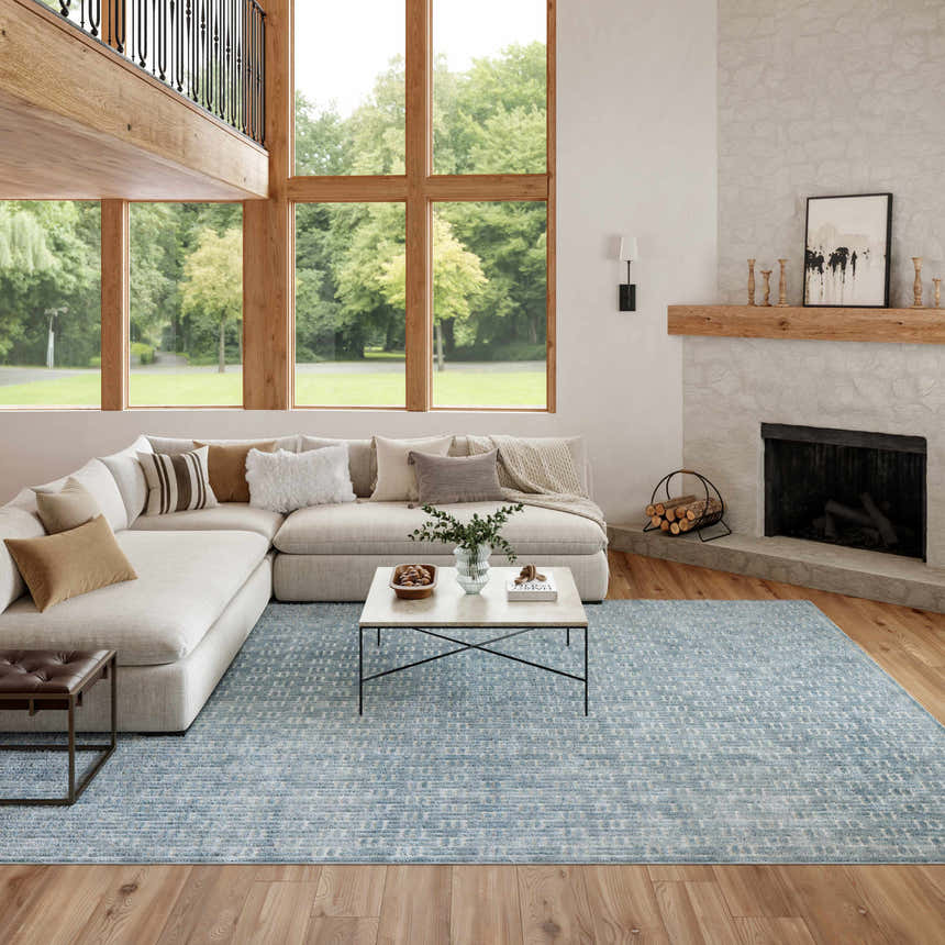 Living room with a sectional sofa and Nourison Charm Blue Ivory Area Rug.