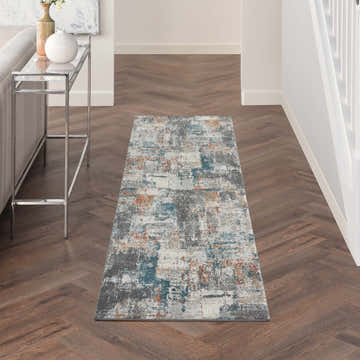 Hallway with Nourison Tangra Grey Multicolor rug. Modern runner rug with gray, teal, and orange abstract pattern.