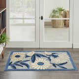 Entryway with Nourison Aloha Blue Grey Outdoor Area Rug. Floral pattern rug in blue, gray, and beige.