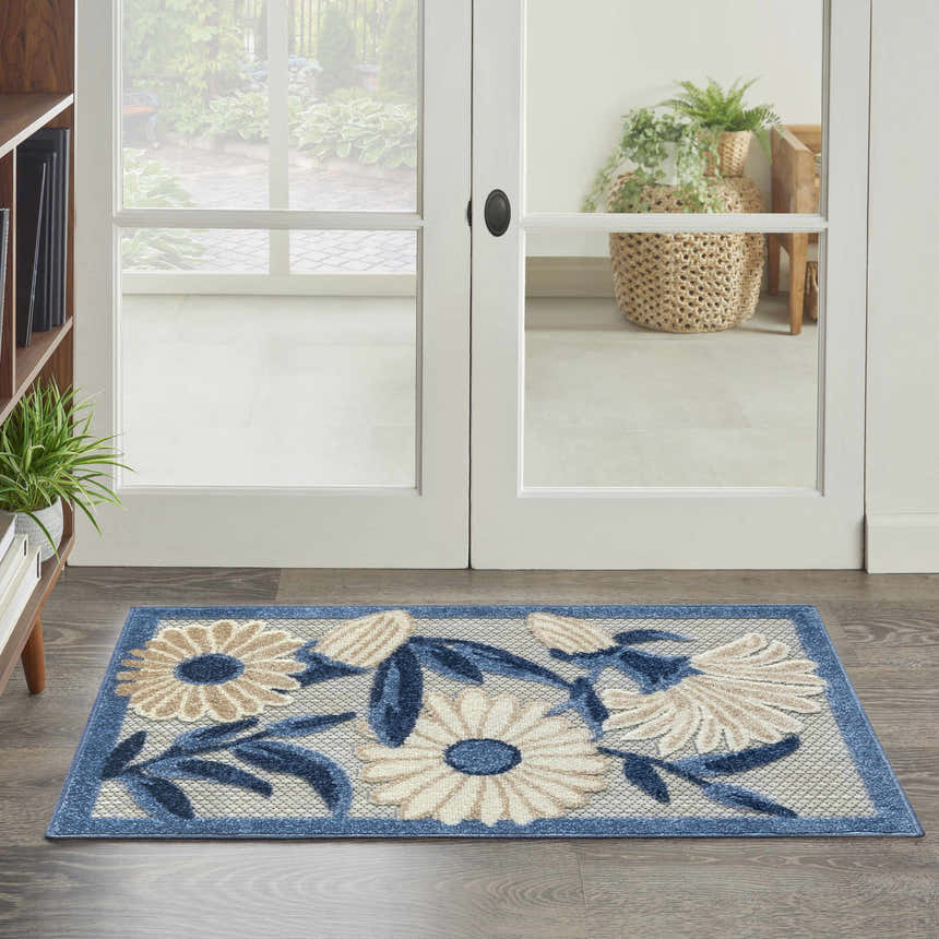 Entryway with Nourison Aloha Blue Grey Outdoor Area Rug. Floral pattern rug in blue, gray, and beige.