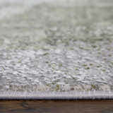 Close-up of the Feizy Cadiz rug showing the gray, green, and silver ikat pattern and soft, textured pile. Pile