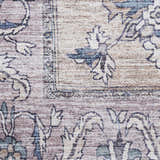 Close-up of the Nourison Grand s Blush Vintage Rug. Blush pink, beige, and blue floral pattern. Machine-made texture.