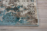 Close-up of Nourison Karma Ivory/Blue rug showing vintage floral pattern and texture. Chestnut, ivory, and blue tones.