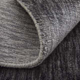 Close-up of the hand-woven Feizy Marlowe rug. Gray and taupe viscose with a subtle chevron pattern and textured pile. Fold