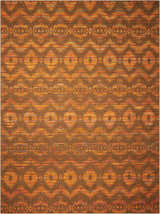 Close-up of Nourison Spectrum Flame Chocolate rug. Features bamboo, wool, and cotton with orange and brown tribal pattern.
