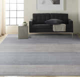Modern living room with a grey sofa and Calvin Klein River Flow Grey area rug.