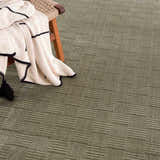 Close-up of the Kazuma Green Washable Area Rug, showcasing its textured, linear pattern and soft gray-green color. Styleshot