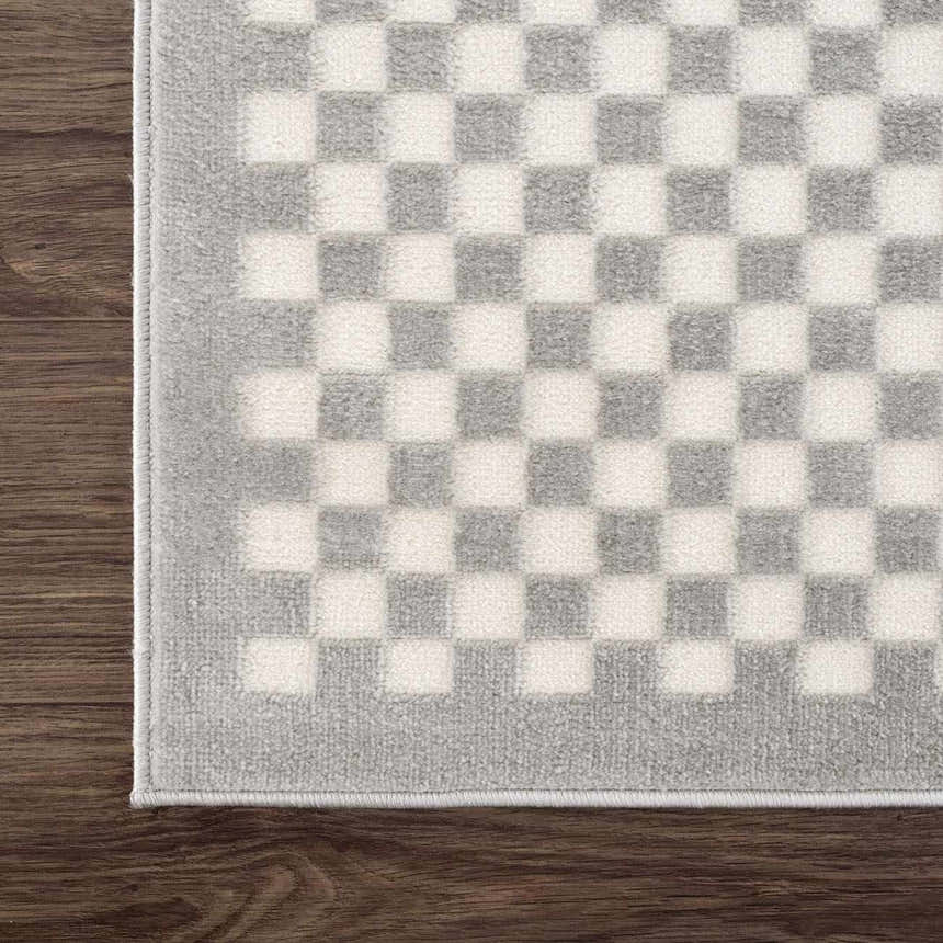 Close-up of the Gaiwan Cream Gray Washable Area Rug, featuring a checkerboard pattern in light gray and off-white. Corner