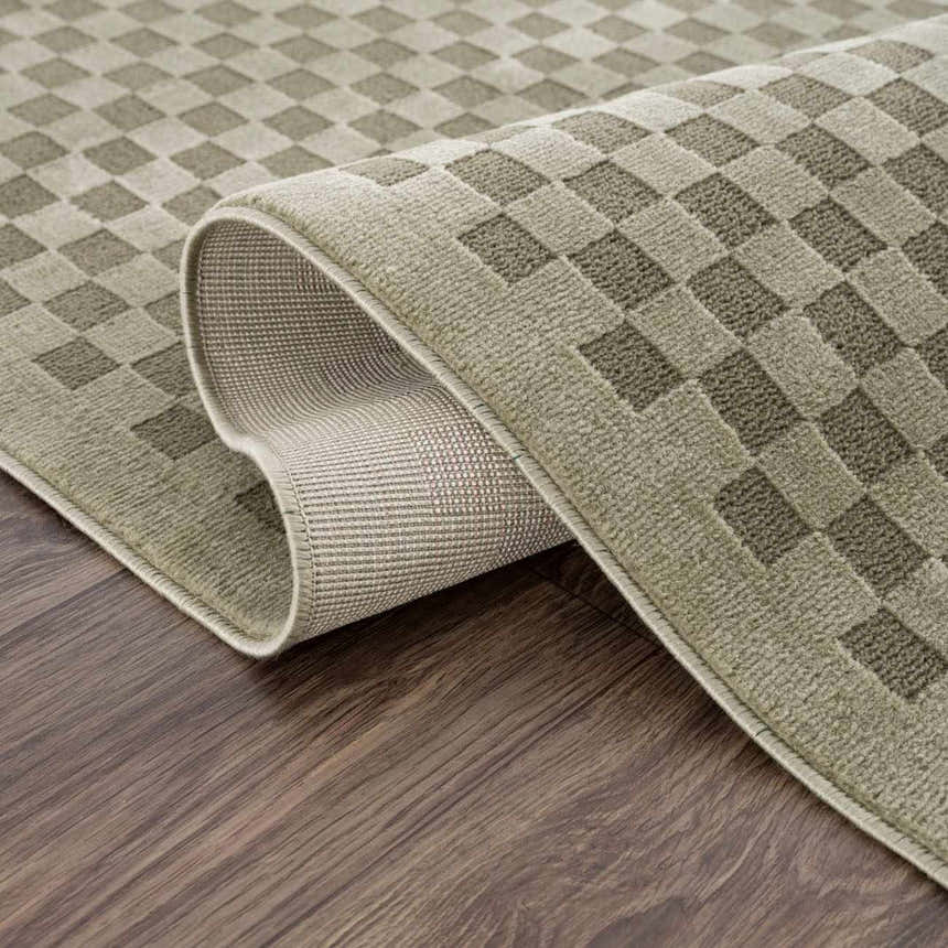 Close-up of Gaiwan Olive Green Washable Area Rug showing its gray green checkered design and durable, machine-woven construction. Fold