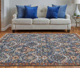 Living room scene with Feizy Kaia rug in blue, orange, and ivory. The rug is styled with a cream sofa and blue pillows. Roomscene-Rectangle