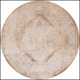 Close-up of a round Nourison Astra Beige Vintage rug. Machine-made with a distressed diamond pattern and floral accents.