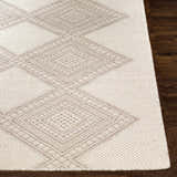 Close-up of the Aanislag Cream Wool Runner showing the diamond pattern and hand woven texture on a dark wood floor. Front