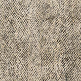 Close-up of the Abiba Area Rug showing its beige and black contemporary pattern and hand-loomed texture. Swatch