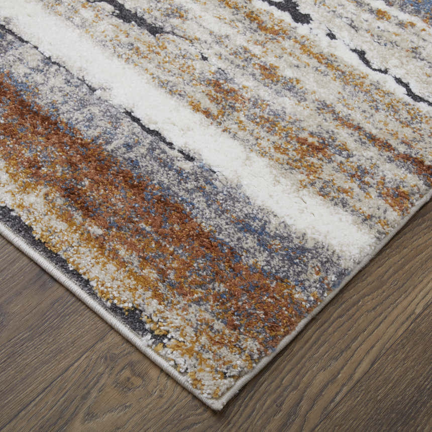 Close-up of Feizy Gilmore Modern Stripes rug. Ivory, orange, and gray stripes on a textured polypropylene rug. Corner