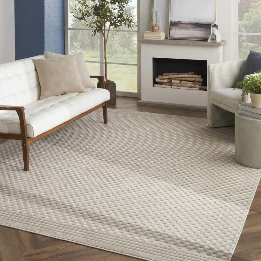 Living room with a white sofa and Nourison Care Free Beige Modern Area Rug.