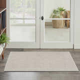 Entryway scene with a Nourison Natural Texture Ivory Mocha area rug on dark wood floors.