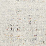 Close-up of the Nourison Motion Multicolor rug. Low pile texture with flecks of black, red, yellow, and blue on a cream background.