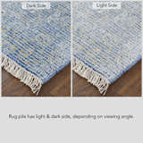 Close-up of Feizy Caldwell rug showing blue and gray tones, distressed look, and light/dark pile depending on viewing angle. Corner