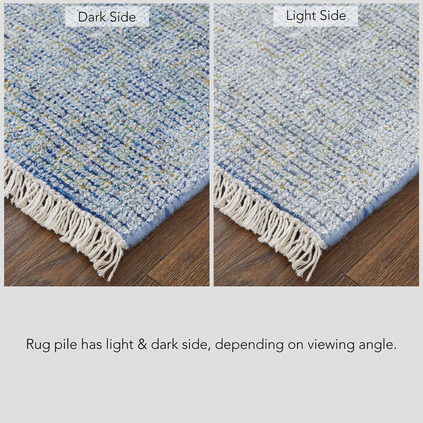 Close-up of Feizy Caldwell rug showing blue and gray tones, distressed look, and light/dark pile depending on viewing angle. Corner